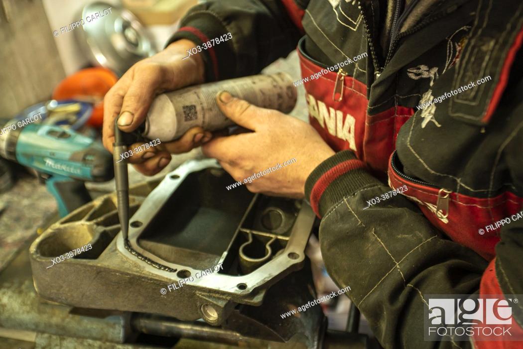 Stock Photo: MILAN, ITALY: Mechanic repairs the gearbox.