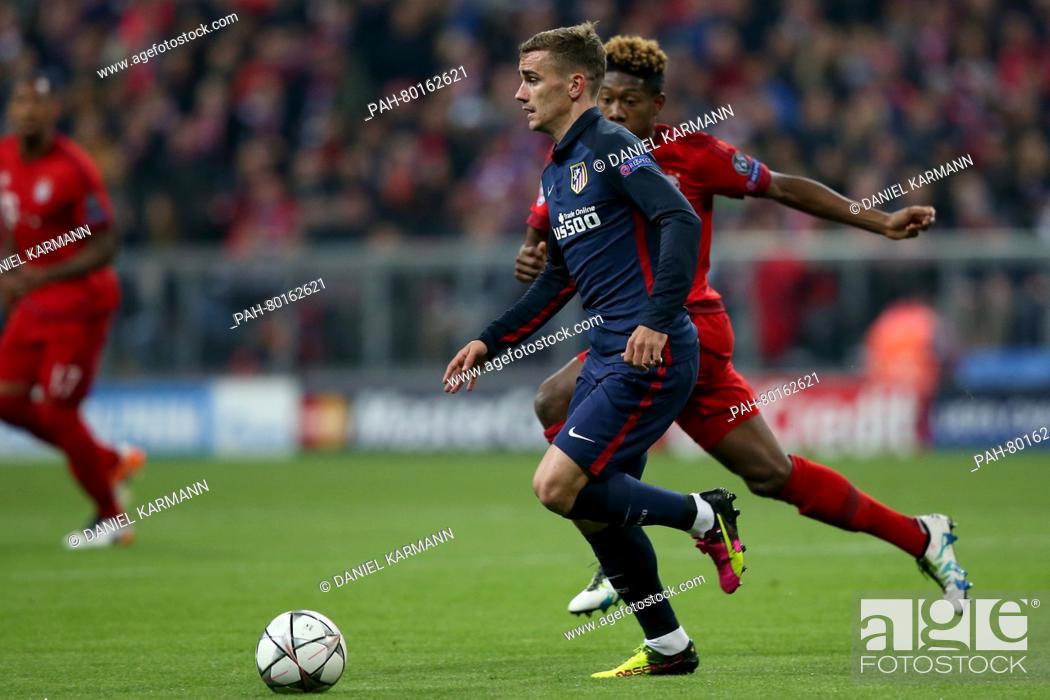 Stock Photo: Madrid's Antoine Griezmann (C) and Bayern's David Alaba vie for the ball during the Champions League semi-final second leg soccer match between Bayern Munich.