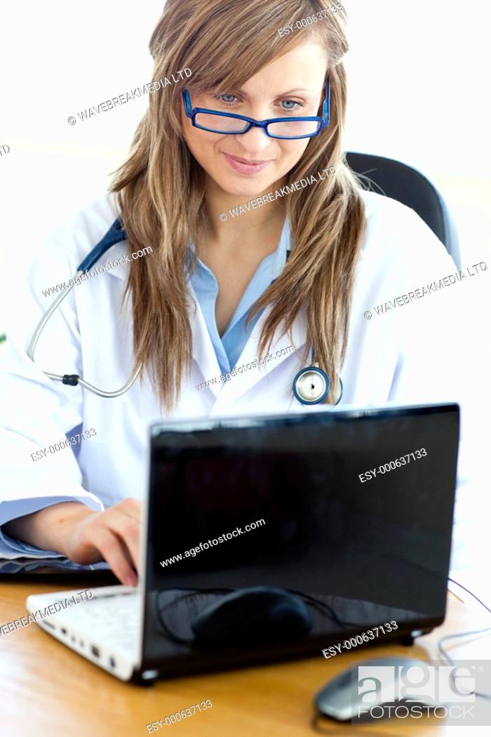Stock Photo: Delighted female doctor working in her office.