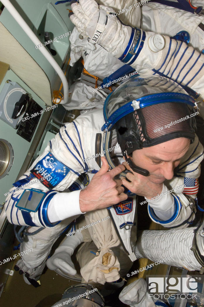 Stock Photo: NASA astronaut Don Pettit, Expedition 31 flight engineer, prepares for a Sokol suit standard leak check in the Soyuz TMA-03M spacecraft in preparation for his.