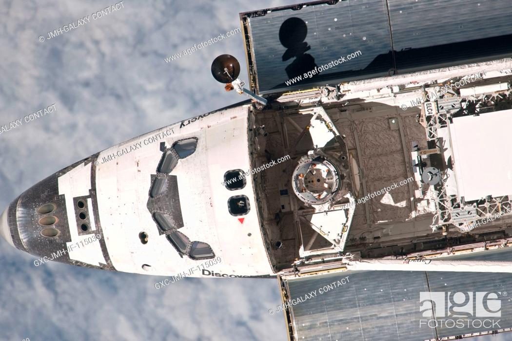 Stock Photo: This partial view of the nose, crew cabin and forward part of the payload bay of the space shuttle Discovery was provided by an Expedition 26 crew member during.