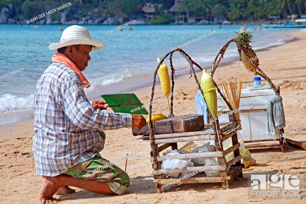 Stock Photo: Beach vendor preparing corn on tiny portable barbecue on the island Ko Tao / Koh Tao, part of the Chumphon Archipelago in Southern Thailand.