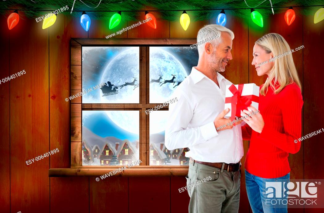 Stock Photo: Composite image of loving couple with gift.