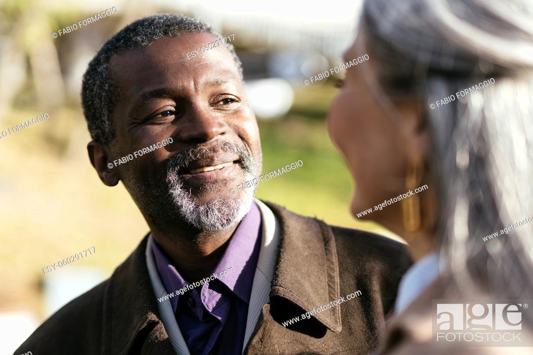 Stock Photo: Storytelling image of a multiethnic senior couple in love.