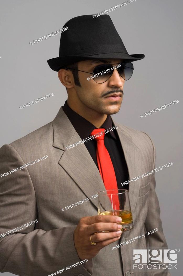 Stock Photo: Actor portraying a businessman holding a wineglass.
