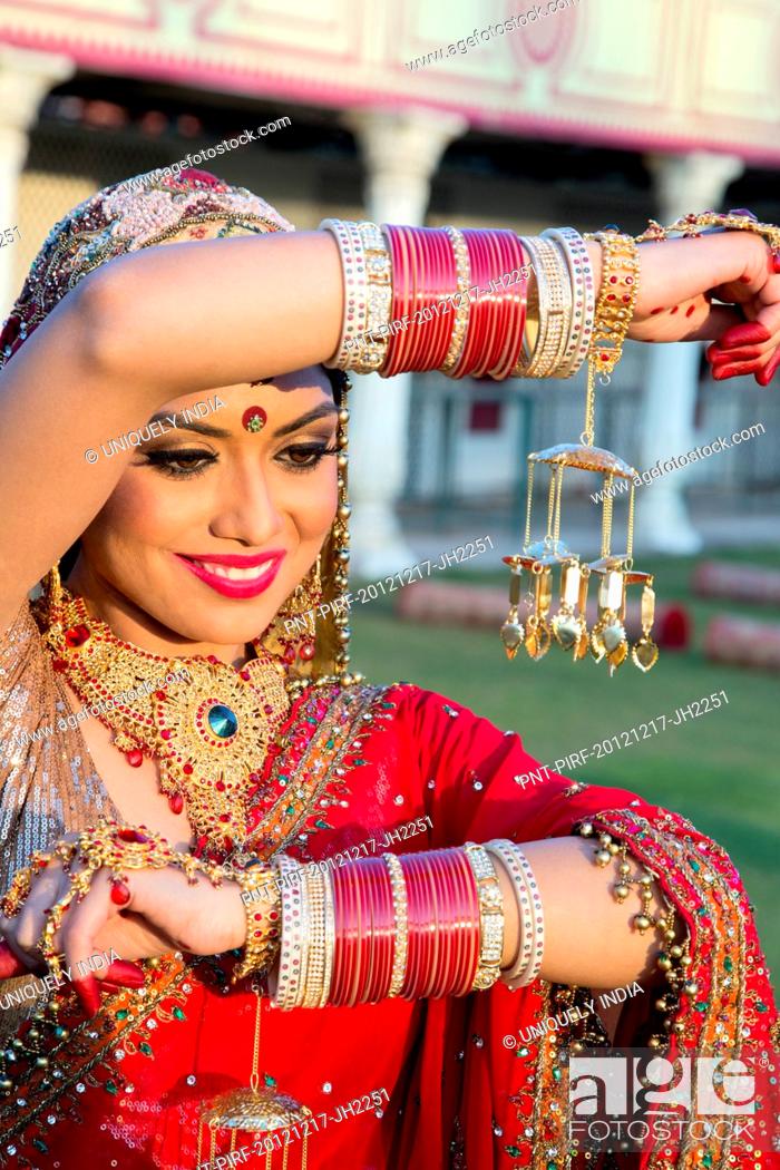 Beautiful Indian bride in traditional wedding dress and posing Stock Photo  - Alamy