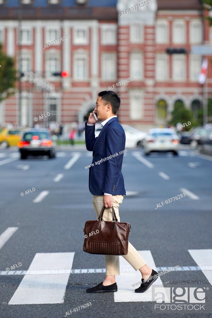 Stock Photo: Young Japanese businessman downtown Tokyo.