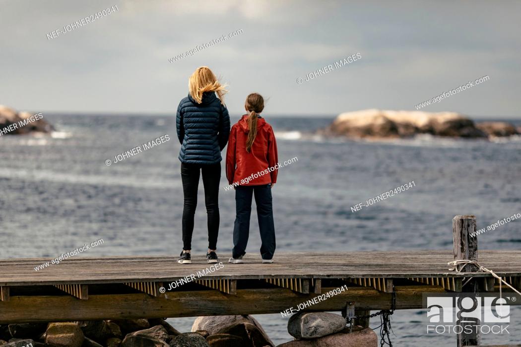 Stock Photo: Mother and daughter standing on jetty.
