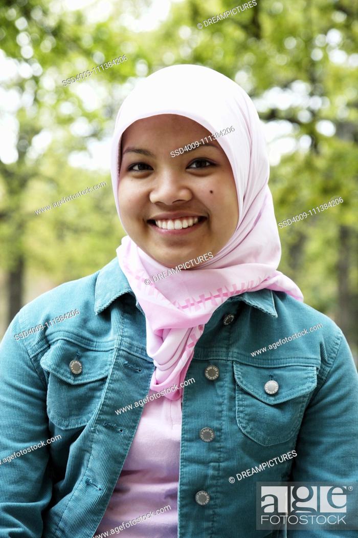 Stock Photo: Indonesian teenager wearing headscarf smiling.