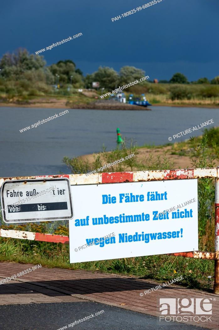 Stock Photo: 25 August 2018, Germany, Bleckede: ""The ferry does not run for an indefinite period of time because of low water"" is written on a sign at the jetty of the.