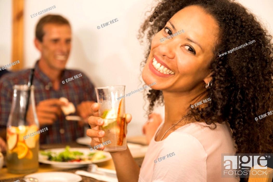 Imagen: Happy Afro-American woman at the restaurant having a drink.