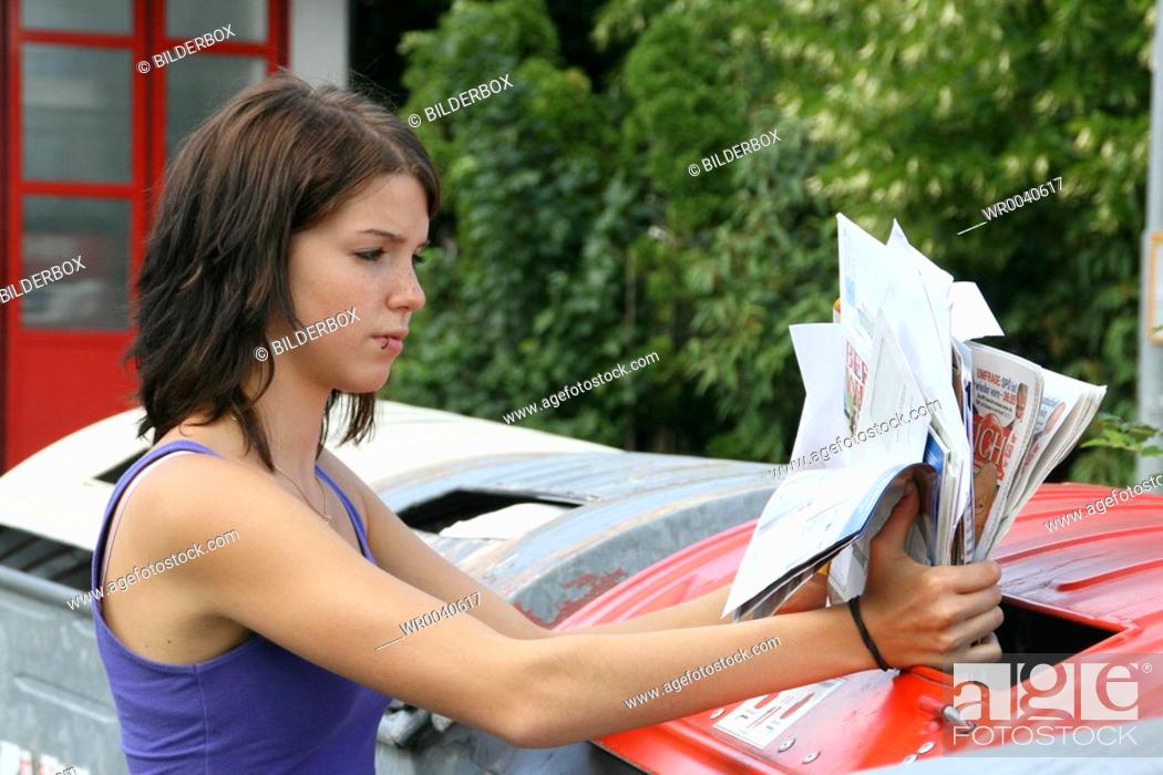 Stock Photo: woman collects waste paper.