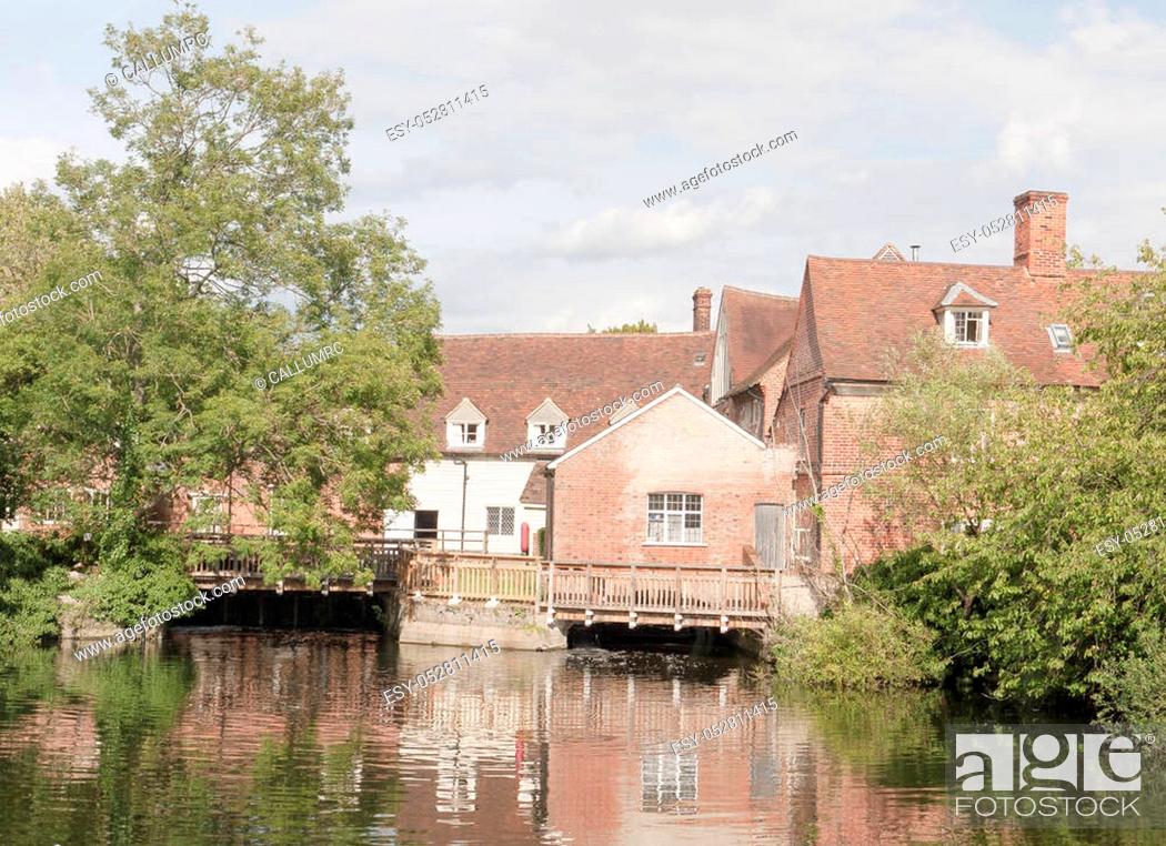 Stock Photo: Mill house at flatford mill in suffolk with river water in front and reflections, as well as trees; Suffolk; England; UK.