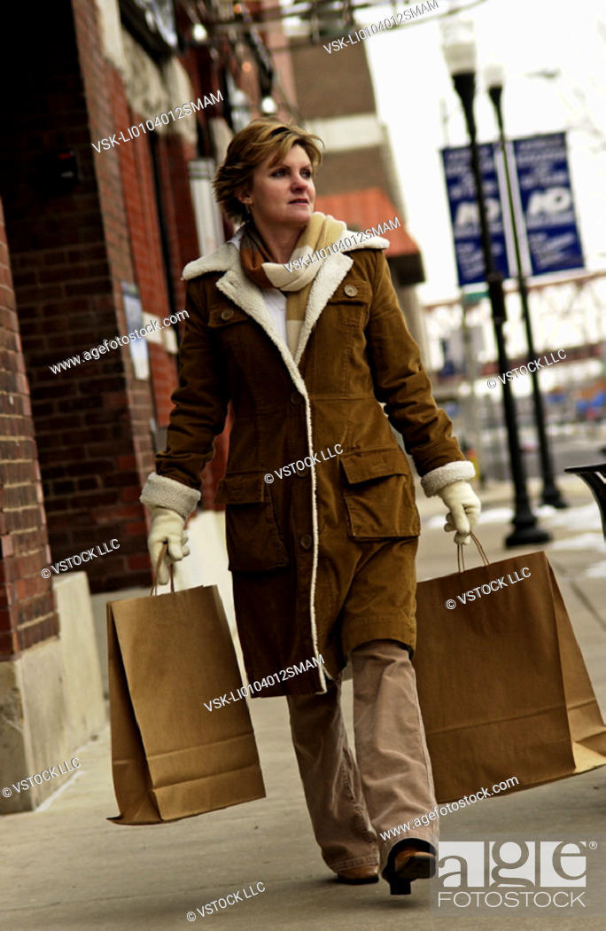 Stock Photo: Woman carrying shopping bags.
