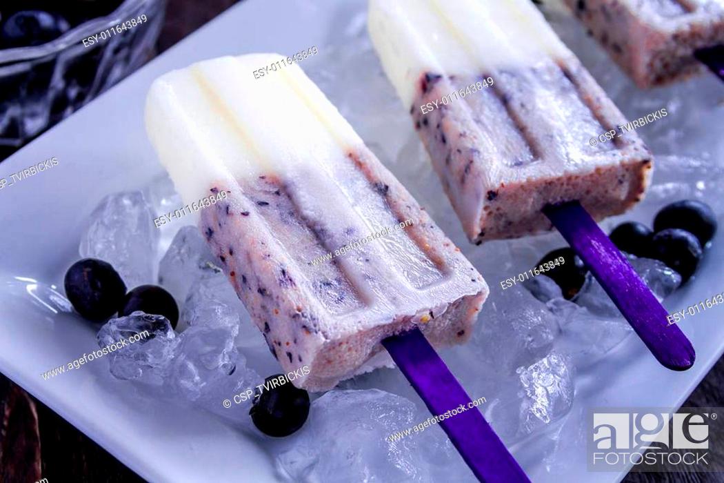 Stock Photo: Homemade Vanilla, Blueberry and Coconut Milk Popsicles.