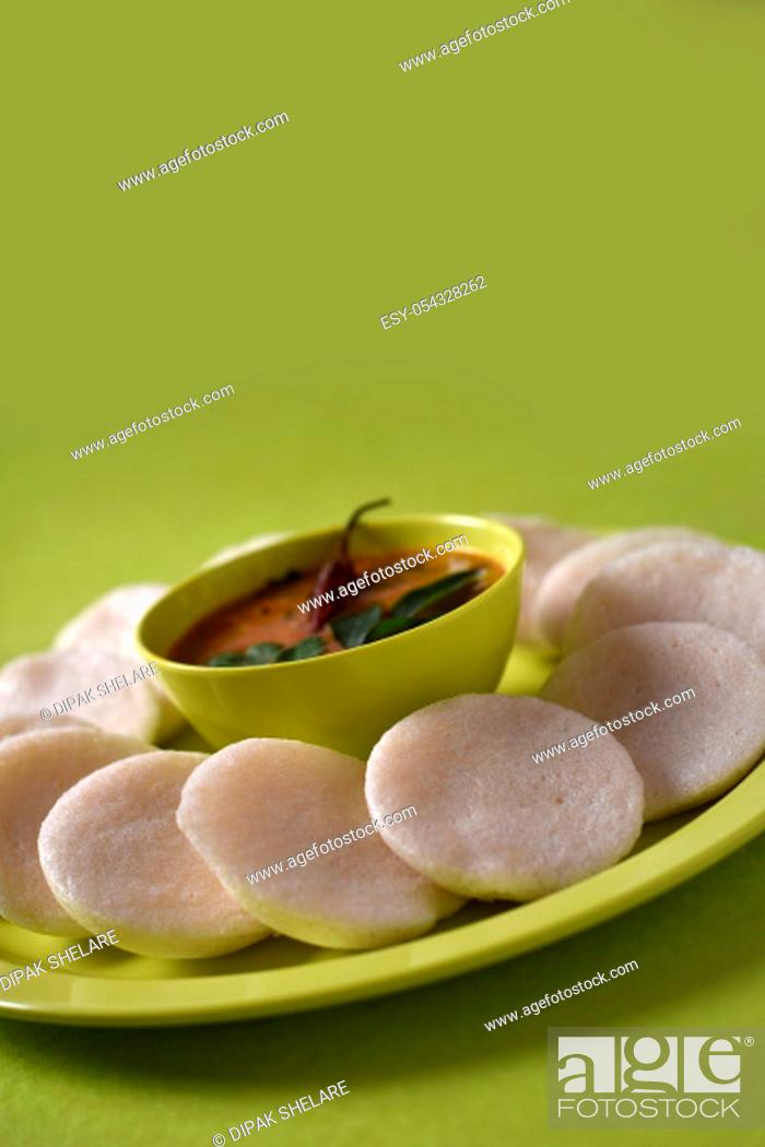 Stock Photo: Idli with Sambar in bowl on green background, Indian Dish : south Indian favourite food rava idli or semolina idly or rava idly.