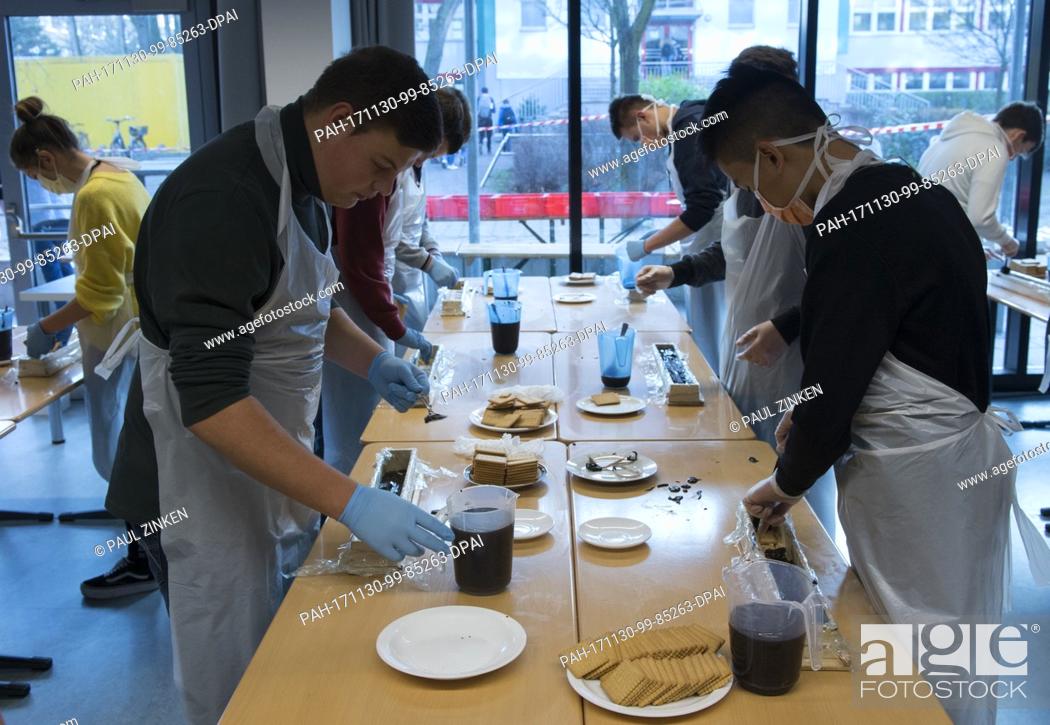 Stock Photo: Students at the Philipp Reis School in Berlin's Lichtenberg helping in the production of a giant hedgehog slice in Berlin, Germany, 30 November 2017.