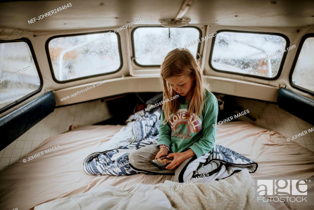 Stock Photo: Girl on boat using cell phone.