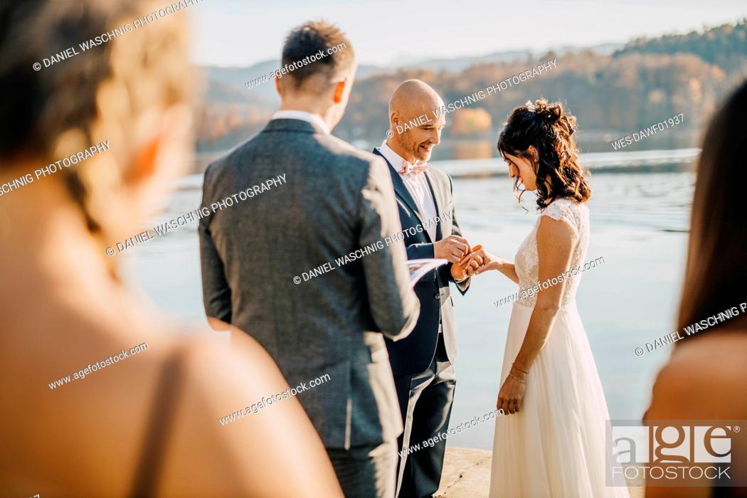 Stock Photo: Bride and groom exchanging wedding rings during ceremony.
