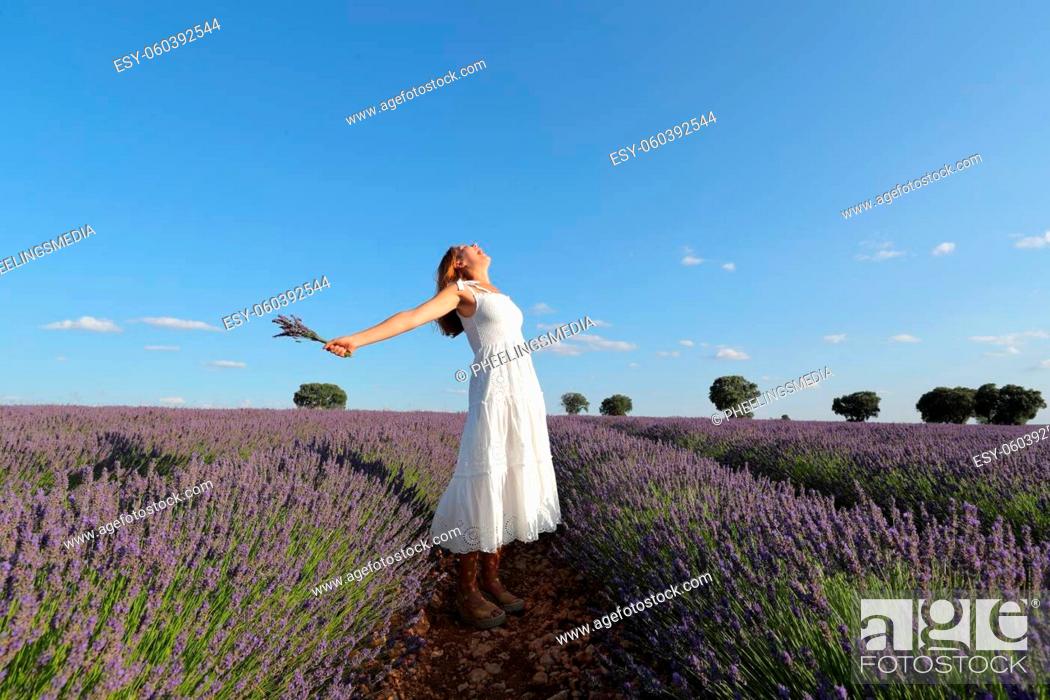 Stock Photo: Woman outstretching holding bouquet in lavender field.
