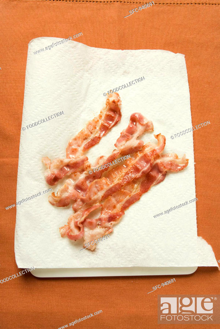 Stock Photo: Fried rashers of bacon on absorbent kitchen paper.