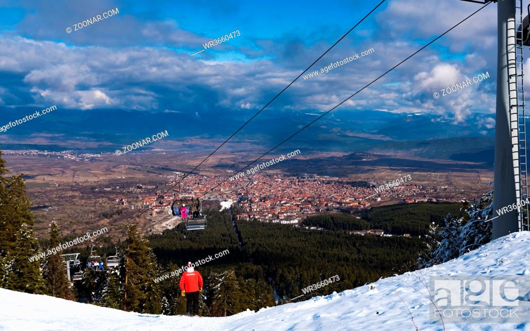 Stock Photo: Bulgaria. Bansko. 10 February 2020.Ski resort in Bansko. Snowy ski slopes and chair ski lifts station in winter mountain ski resort.