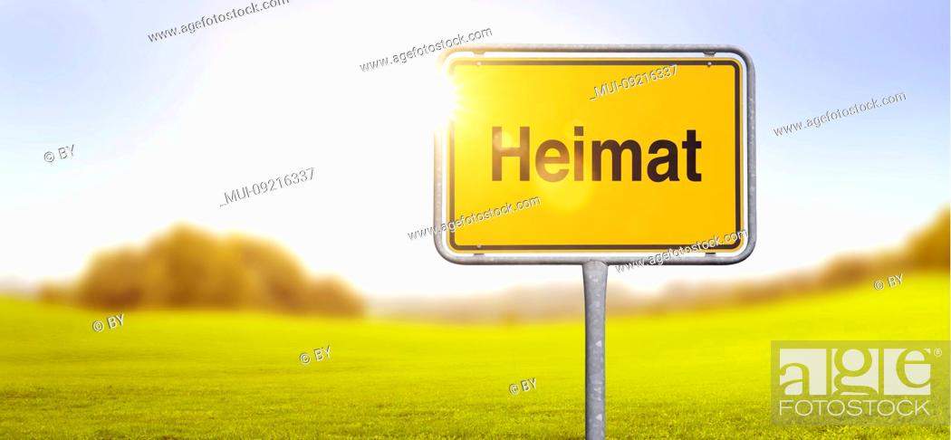 Stock Photo: Shield 'Heimat' in front of landscape in backlight [M].