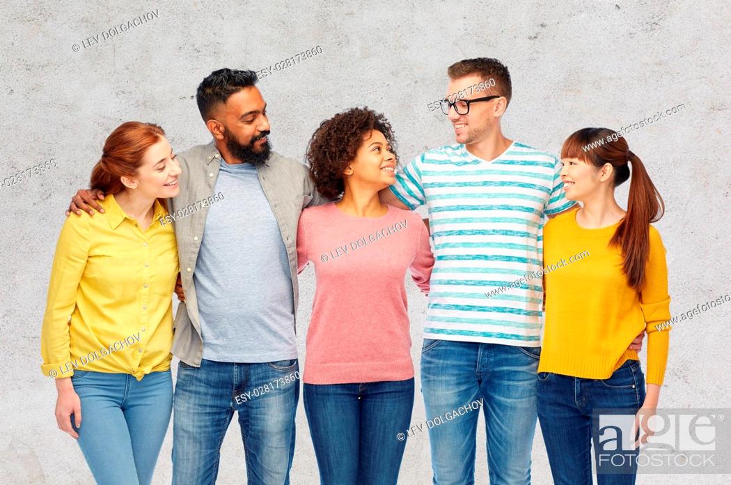 Stock Photo: diversity, race, ethnicity and people concept - international group of happy smiling men and women over gray concrete background.