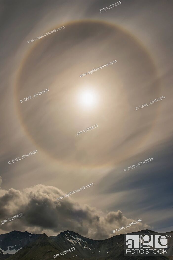 Stock Photo: A 22 degree halo fills the sky over the Chigmit Mountains within Lake Clark National Park & Preserve, Alaska.
