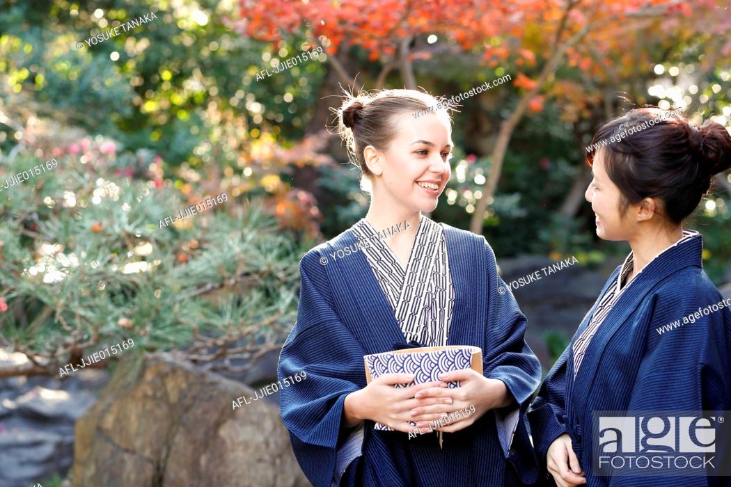 Stock Photo: Caucasian woman wearing yukata with Japanese friend at traditional ryokan, Tokyo, Japan.