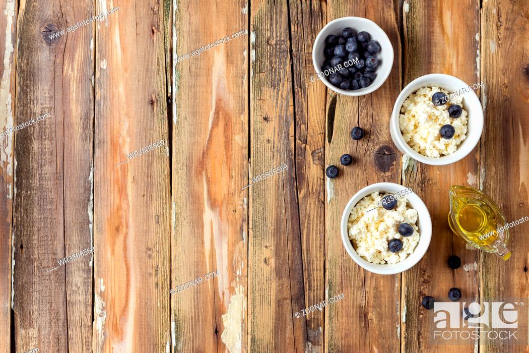 Stock Photo: Fresh cottage cheese with sour cream, blueberries and honey. Healthy breakfast. Free space for text. Top view.