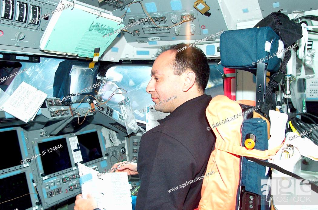 Stock Photo: Astronaut Mark L. Polansky, pilot, is pictured at the pilot's station on the flight deck of the Space Shuttle Atlantis during Flight Day 1.