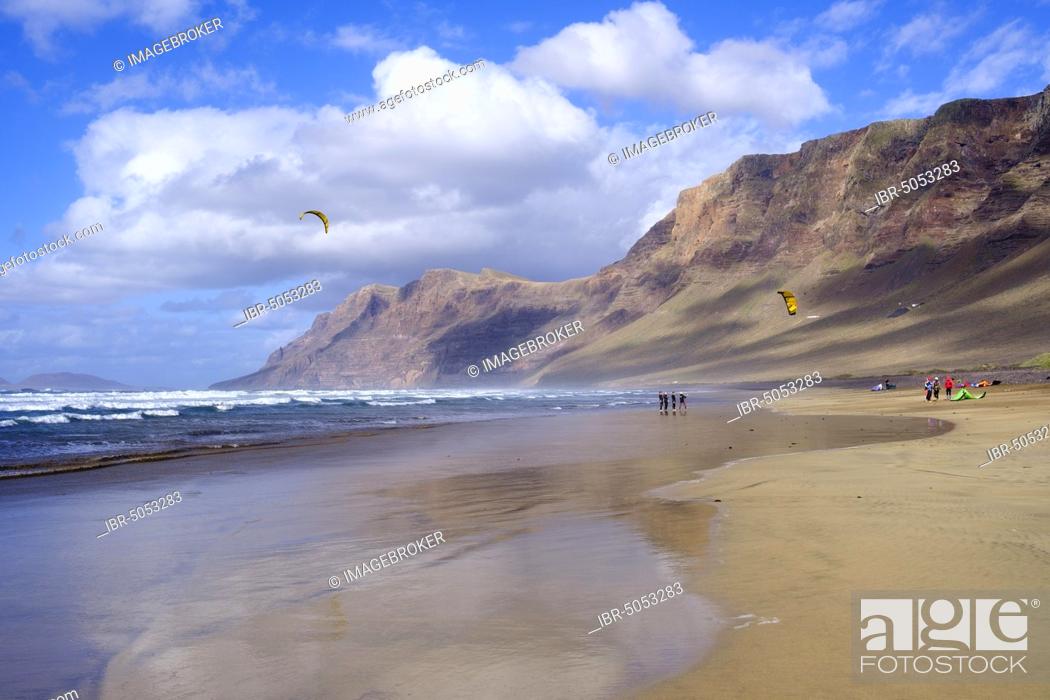 Stock Photo: Kitesurfers, Playa de Famara near Caleta de Famara, Risco de Famara, Lanzarote, Canary Islands, Spain, Europe.