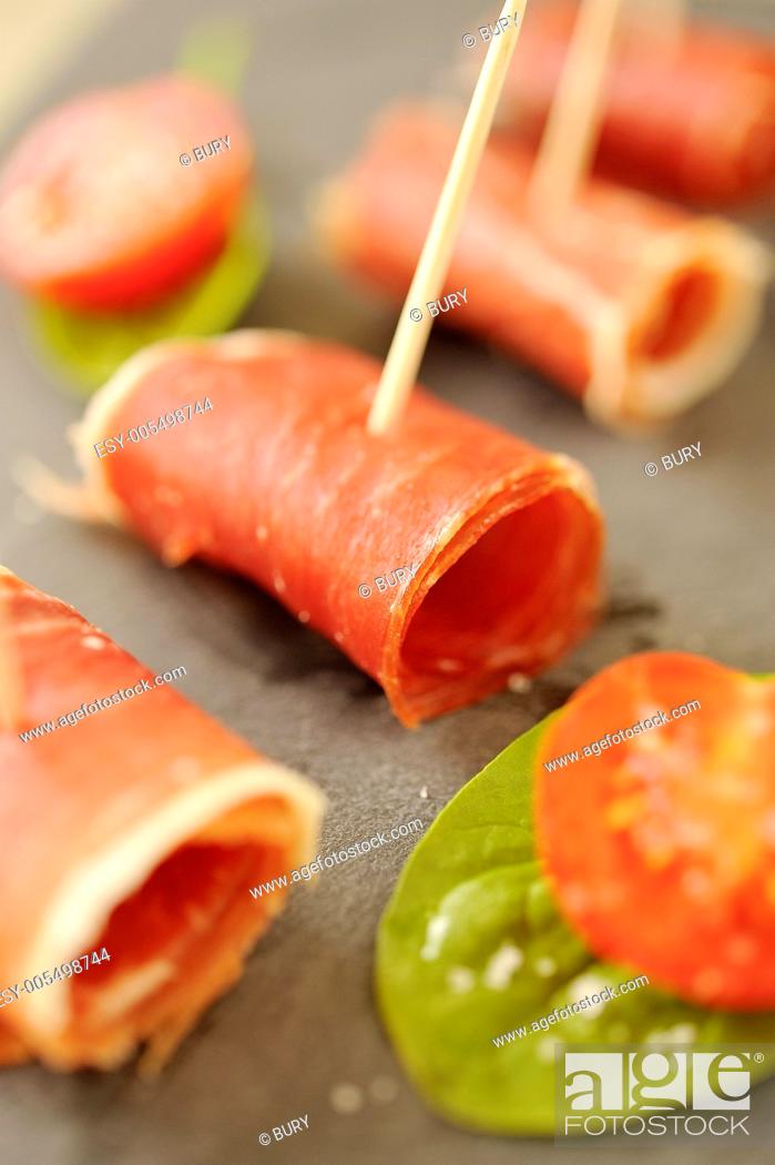 Stock Photo: Sliced and rolled Pata negra ham appetizers.