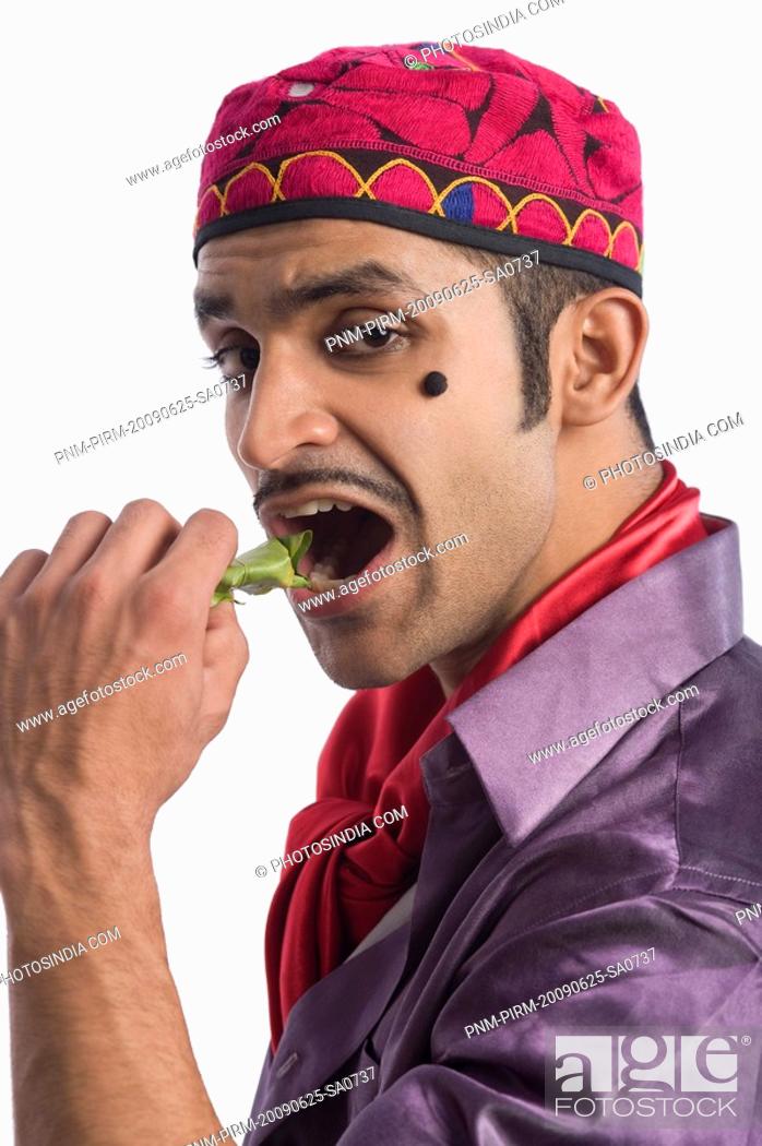 Stock Photo: Portrait of an actor portraying a tapori eating pan.