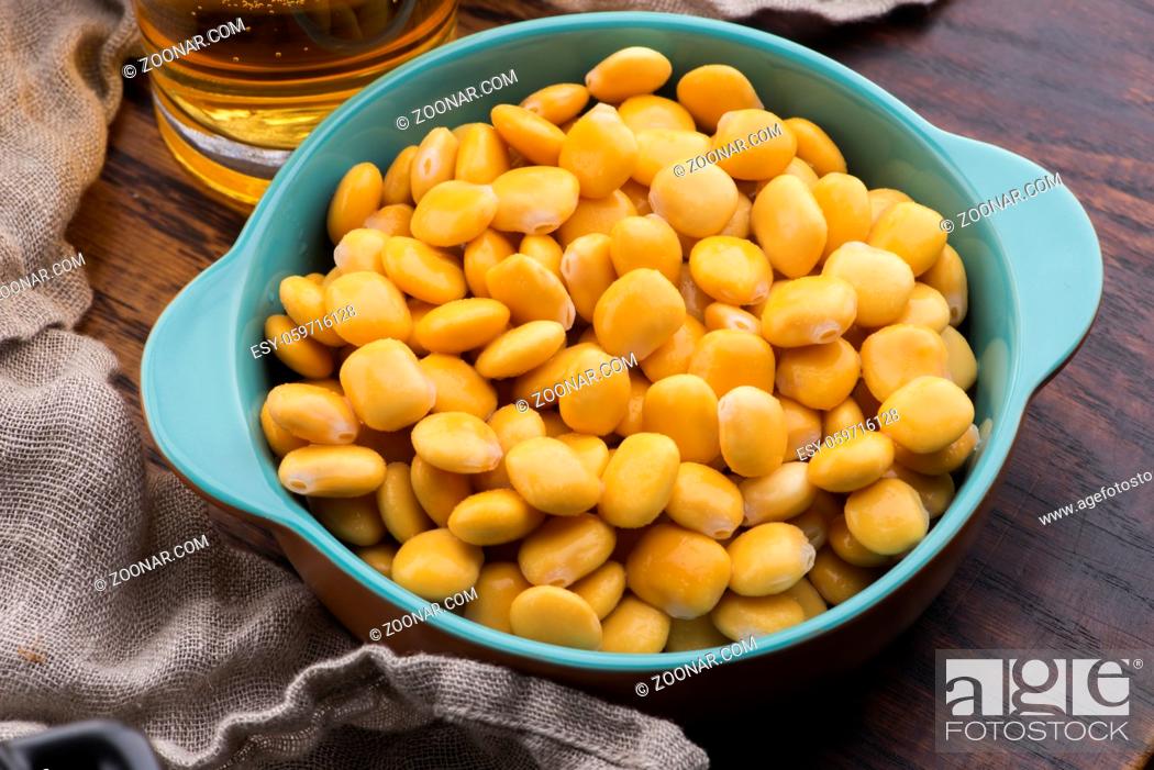 Stock Photo: Tasty lupins and glass of beer. Beverage, legume.