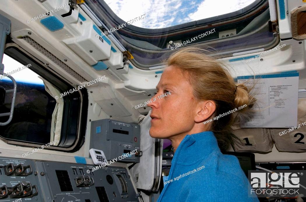 Stock Photo: Astronaut Karen Nyberg, STS-124 mission specialist, works the controls on the aft flight deck of Space Shuttle Discovery during flight day two activities.