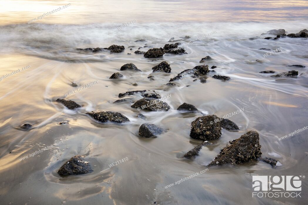Stock Photo: Long exposure of water and rocks on Driftwood Beach - Jekyll Island, Georgia, USA.
