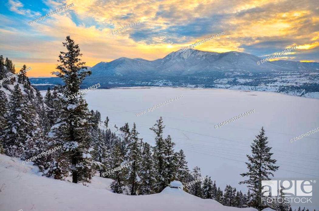 Stock Photo: Winter Sunset over a snow covered Columbia Lake looking at the Purcell Mountains, British Columbia, Canada.