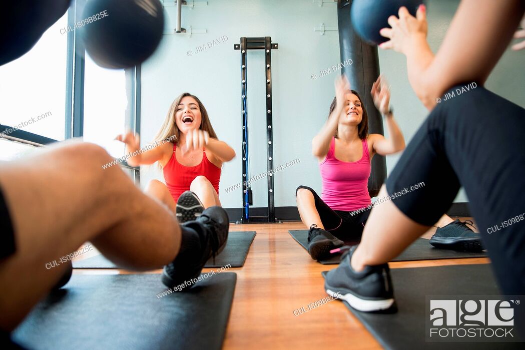 Stock Photo: Friends training with medicine ball in gym.