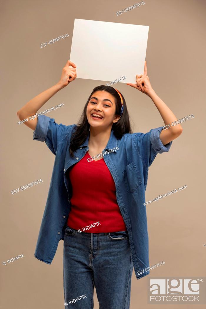 Stock Photo: Portrait of a young woman holding white sheet with her both hands.