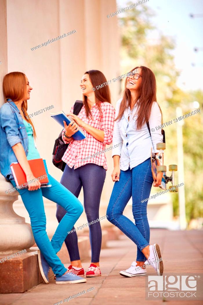Stock Photo: Group of college students talking by their university.