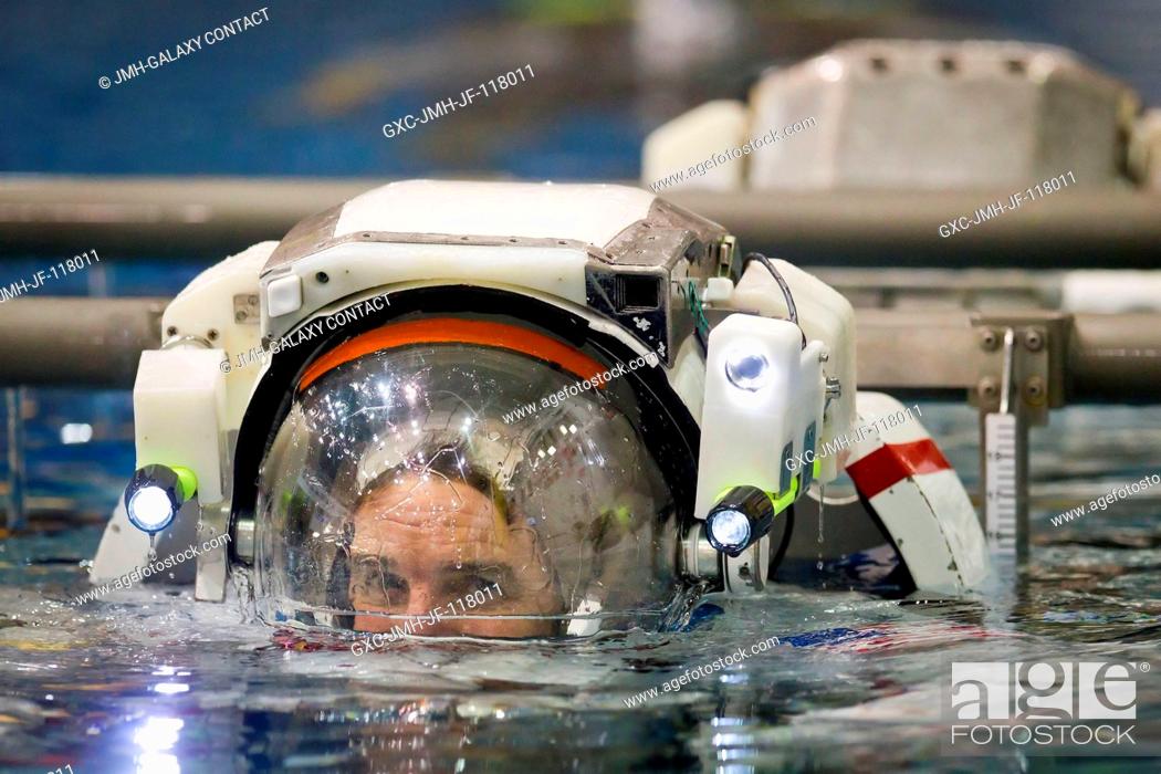 Stock Photo: NASA astronaut Rex Walheim, STS-135 mission specialist, is lowered into the water March 22, 2011 to train for a contingency spacewalk in the Neutral Buoyancy.