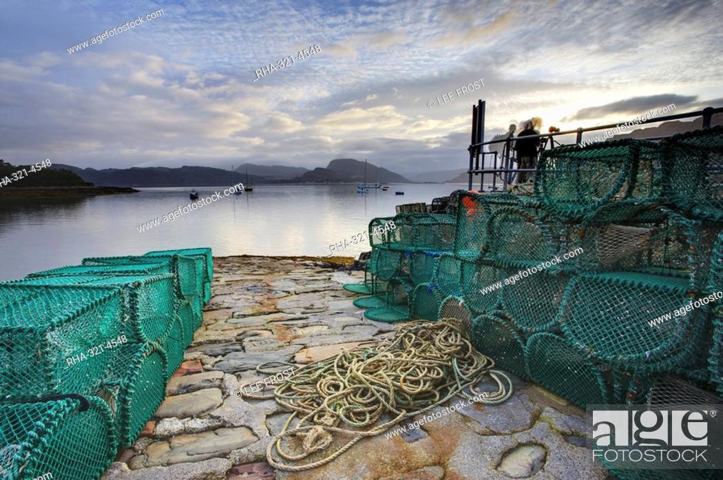 Stock Photo: View out to sea from stone slipway at dawn, with lobster pots and ropes in foreground, Plokton, near Kyle of Lochalsh, Highland, Scotland, United Kingdom.