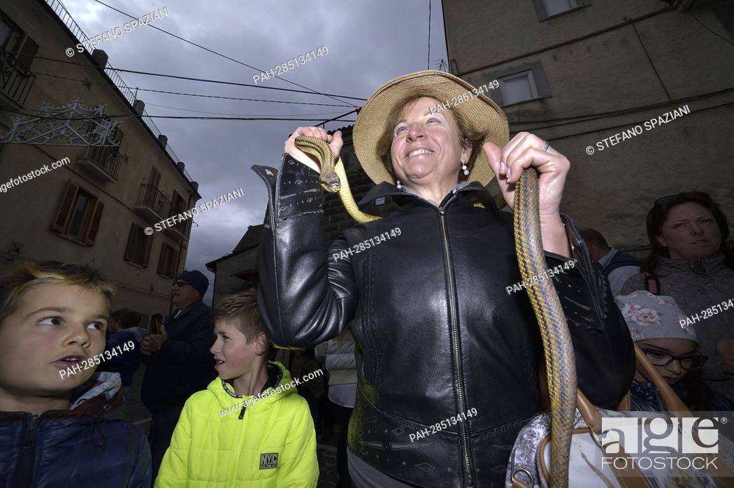 Stock Photo: After two years of interruption due to the pandemic, the procession of snakes in Cocullo takes place on 1 May 2022.People with snakes in hand before the.