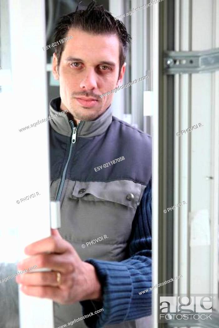 Stock Photo: Worker installing a door.