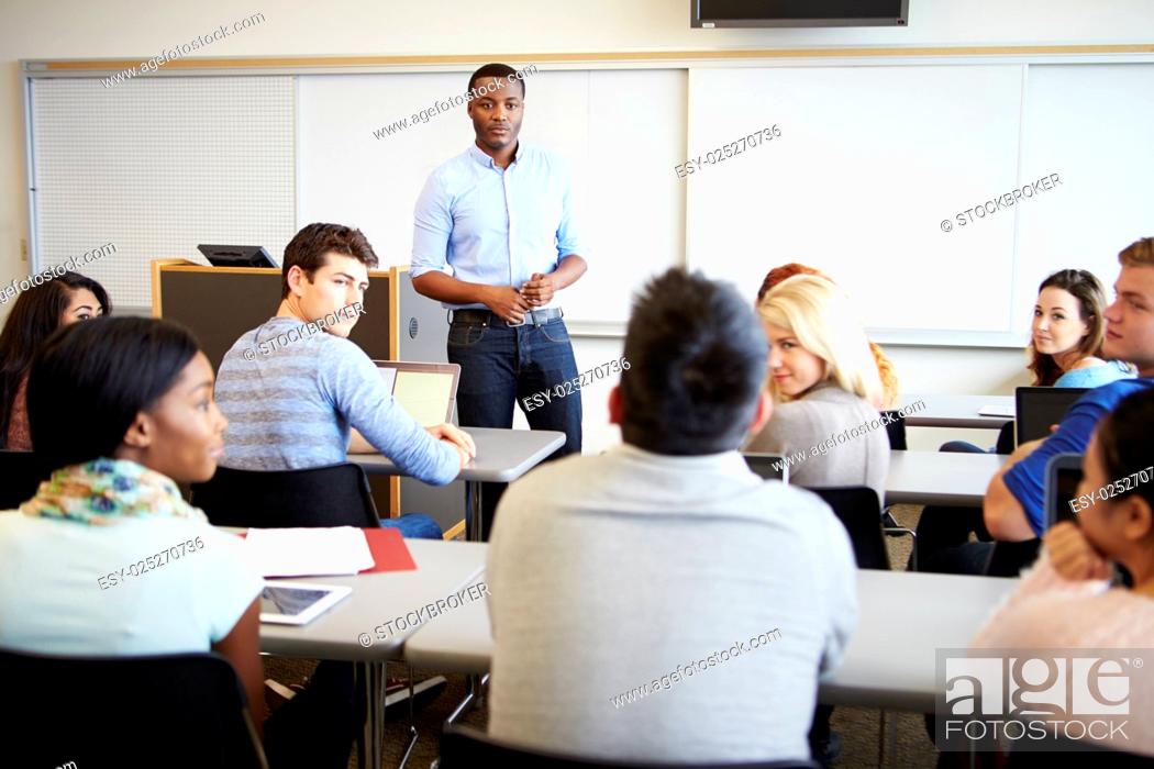 Stock Photo: Male Tutor Teaching University Students In Classroom.