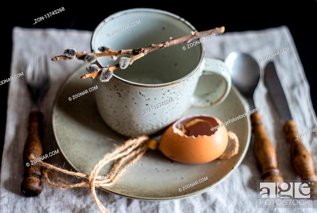 Stock Photo: Festive table setting for Easter holiday dinner decorated with flowers and eggs.