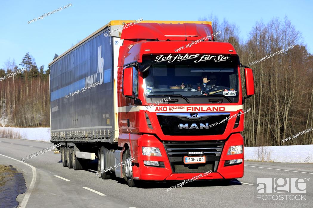 Stock Photo: Salo, Finland - February 22, 2019: Red MAN TGX 18. 450 truck of AKO Spedition Oy pulls cargo trailer along highway in South of Finland on day of winter.