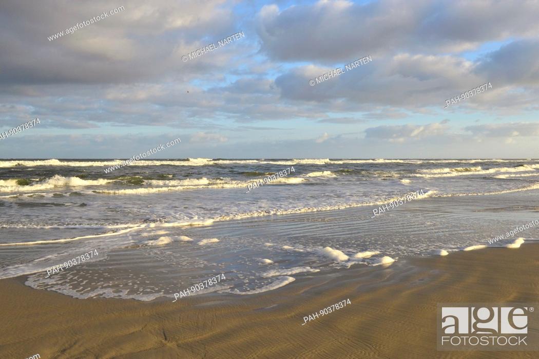 Stock Photo: Clouds and blue sky above the foaming seawater by the wet waterside from the island Borkum, 20 October 2016 | usage worldwide.